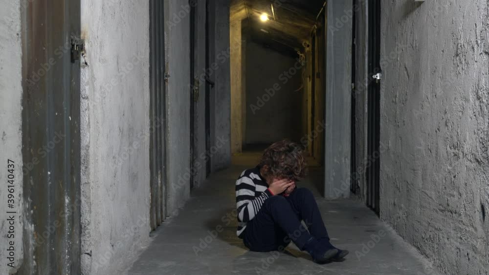 sad upset boy sitting in corner lifestyle . Child punished sitting crying in the corner. Domestic violence concept. Child abuse unhappy during Covid-19 Coronavirus lockdown quarantine home sad upset boy sitting in corner lifestyle . Child punished sitting crying in the corner. Domestic violence concept. Child abuse unhappy during Covid-19 Coronavirus lockdown quarantine home