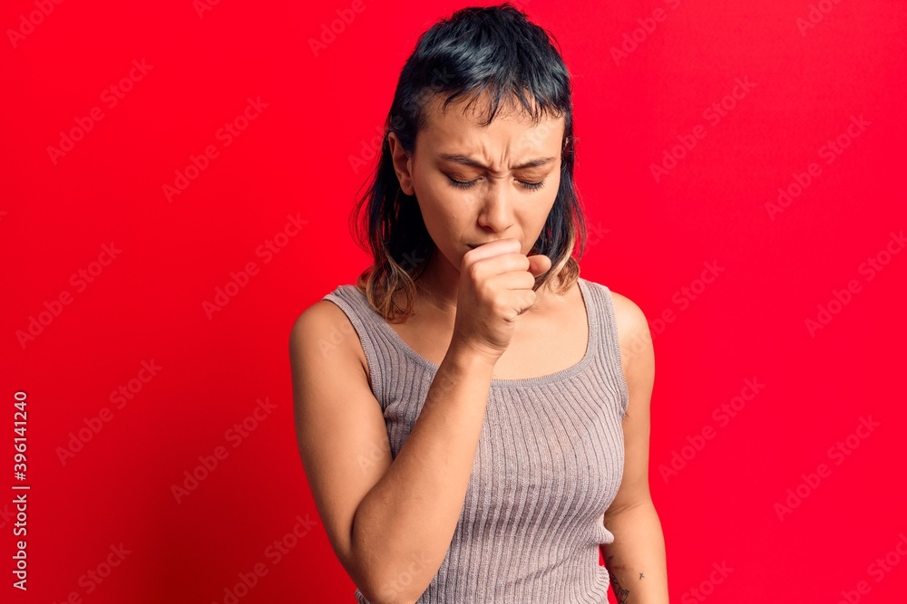 Young woman wearing casual clothes feeling unwell and coughing as symptom for cold or bronchitis. health care concept. Young woman wearing casual clothes feeling unwell and coughing as symptom for cold or bronchitis. health care concept.