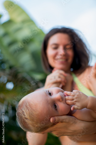 Young mother with her newborn son in her arms. Soft focus