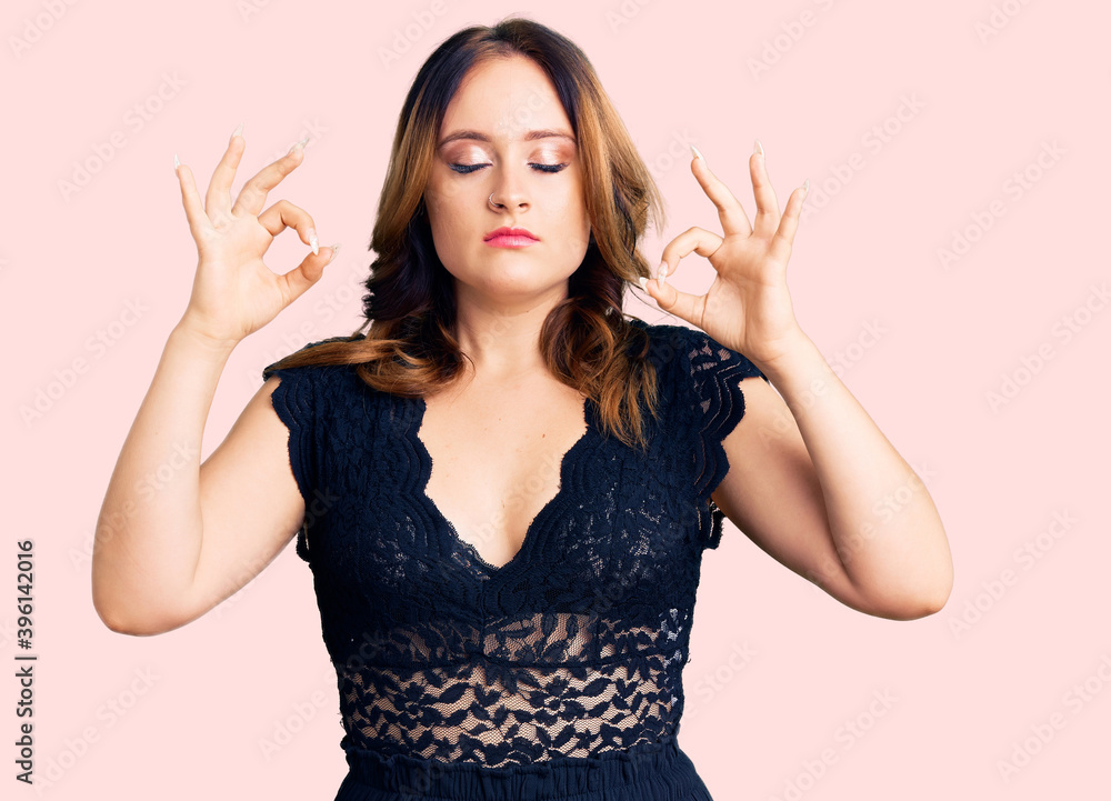 Young beautiful caucasian woman wearing elegant dress relax and smiling with eyes closed doing meditation gesture with fingers. yoga concept. Young beautiful caucasian woman wearing elegant dress relax and smiling with eyes closed doing meditation gesture with fingers. yoga concept.
