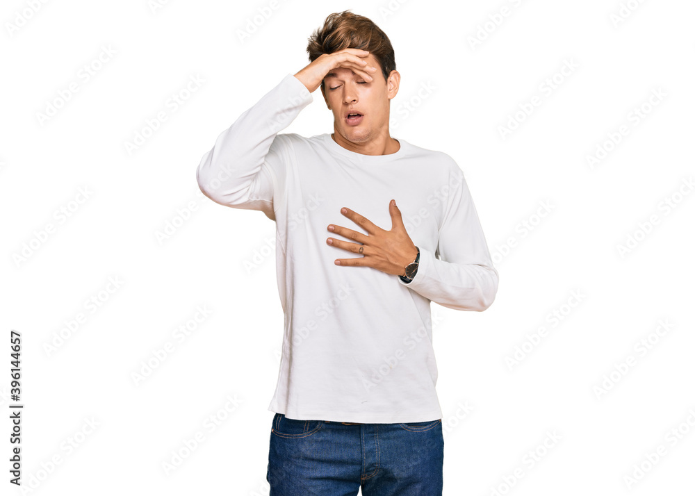 Fototapeta premium Handsome caucasian man wearing casual white sweater touching forehead for illness and fever, flu and cold, virus sick