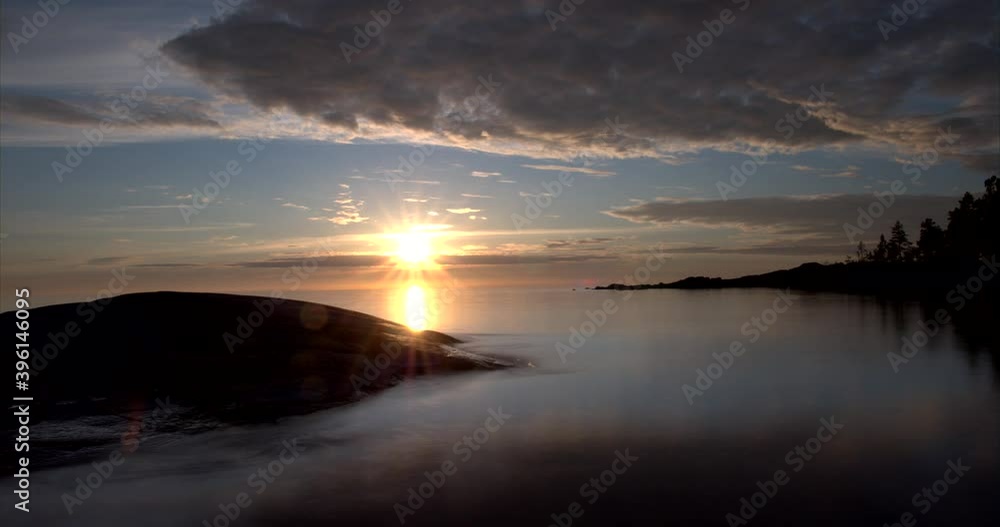 Breathtaking sunset overlooking small bay and horizon with passing clouds. Time lapse. Breathtaking sunset overlooking small bay and horizon with passing clouds. Time lapse.