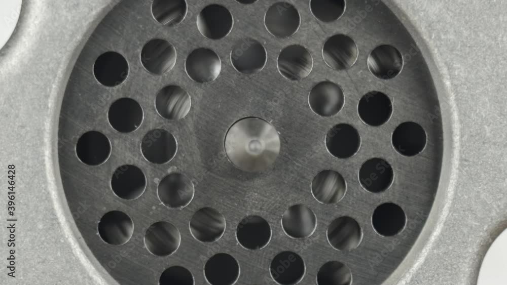 Slow motion. Close-up of turning on a meat grinder. Rotation of the grinder knife. Electric meat grinder. Slow motion. Close-up of turning on a meat grinder. Rotation of the grinder knife. Electric meat grinder.