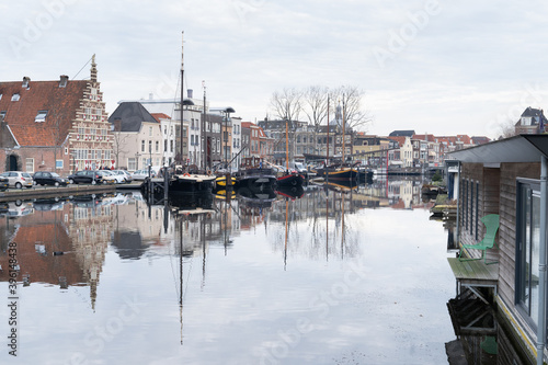 Canal ( gracht ) at the Old Harbour and Galgewater with traditional houses in Leiden, The Netherlands on a cloudy autumn day with trees and boats photo