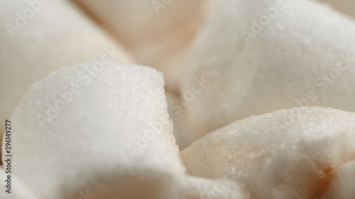 Many delicious sweet white marshmallows close-up. Swim on cocoa. Macro shooting. A cup of hot cocoa chocolate sprinkled. Soft focus, depth of field