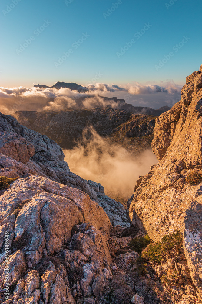Beautiful sunset in the “Serra de Tramuntana” mountains. “Puig Major” peak among a sea of clouds viewed from “Puig de Massanella” mountain in Majorca island.