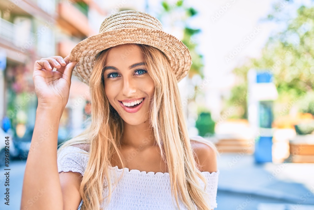 Young blonde tourist girl smiling happy walking at the city.