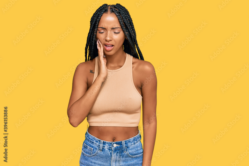 Beautiful hispanic woman wearing casual clothes touching mouth with hand with painful expression because of toothache or dental illness on teeth. dentist Beautiful hispanic woman wearing casual clothes touching mouth with hand with painful expression because of toothache or dental illness on teeth. dentist