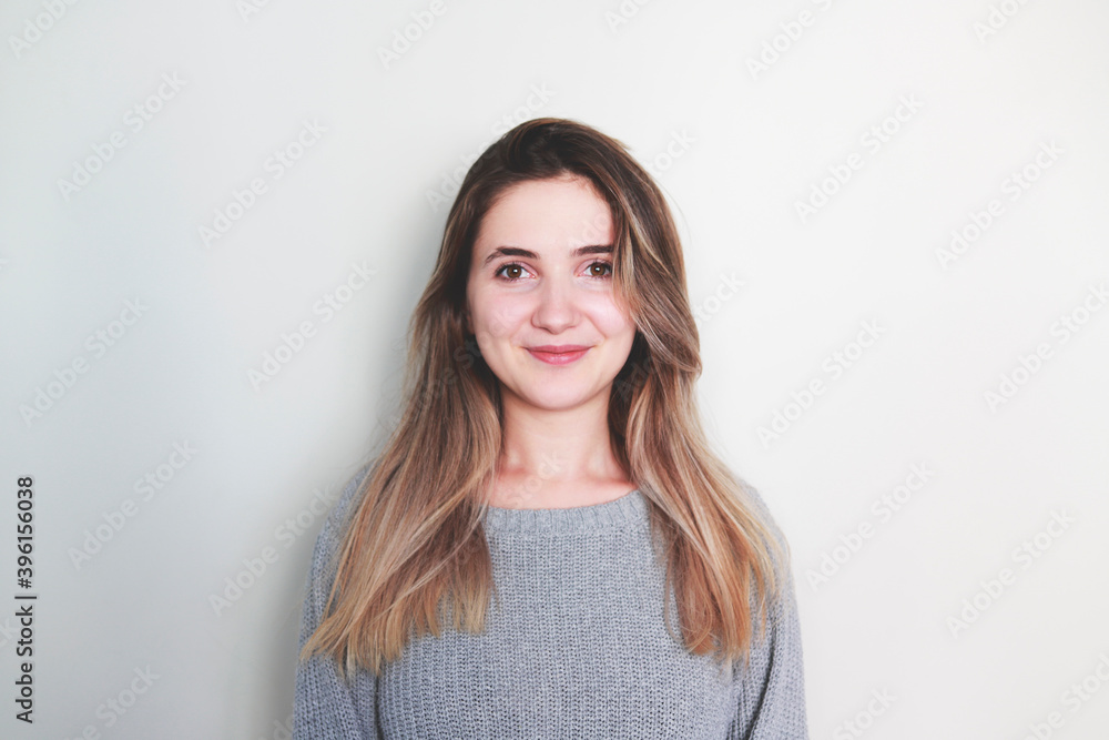 Portrait of young beautiful cute cheerful girl smiling looking at camera over white background. Portrait of young beautiful cute cheerful girl smiling looking at camera over white background.