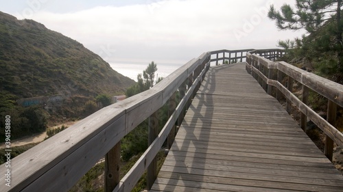  Wooden walk to the beach on a side of a hill in Portugal © Jitka