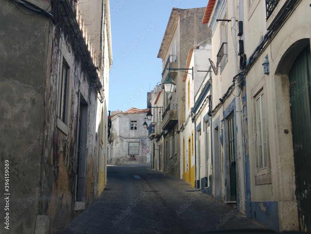 Old empty Portuguese town with narrow streets and beaten buildings