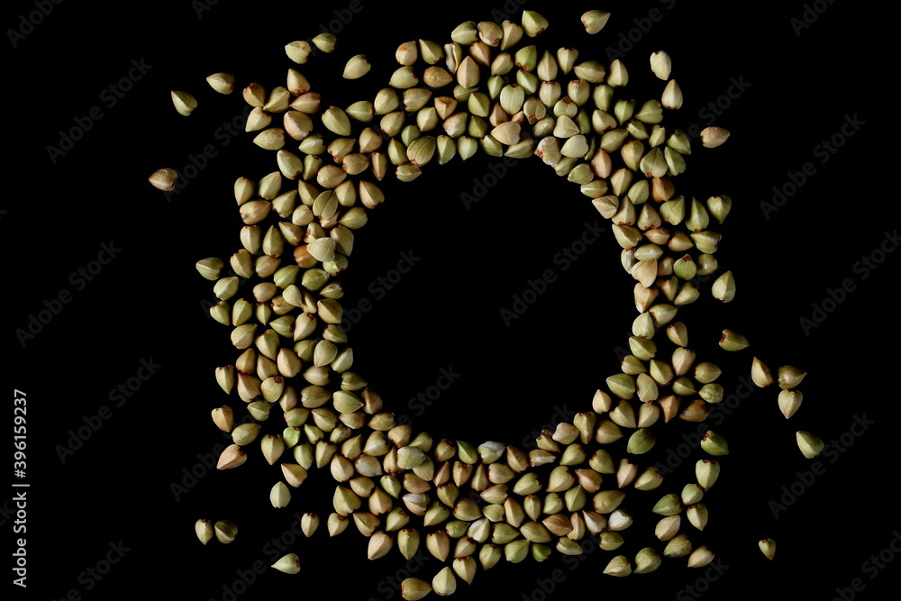 Buckwheat pile isolated on black background, top view Buckwheat pile isolated on black background, top view