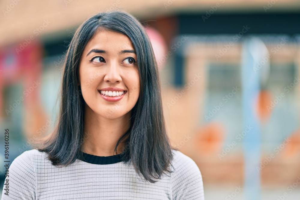 Young hispanic woman smiling happy walking at the city. Young hispanic woman smiling happy walking at the city.
