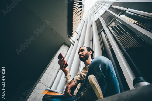  Man using modern phone outdoor.