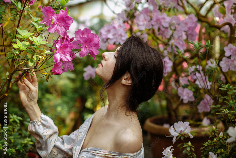 Fototapeta premium a girl in a long dress in a big garden