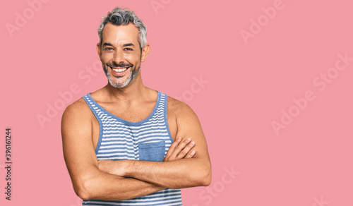 Billede på lærred Middle age grey-haired man wearing casual style with sleeveless shirt happy face smiling with crossed arms looking at the camera