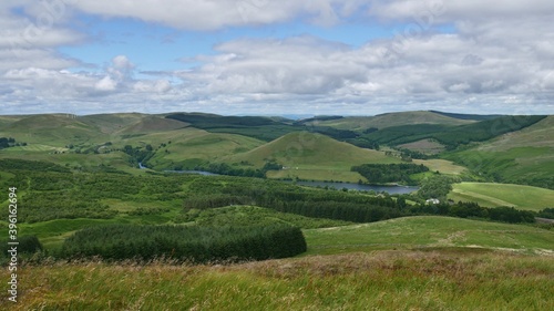 View of Glendevon  Castlehill Reservoir and green Ochil Hills from the peak of a hill above Muckhart
