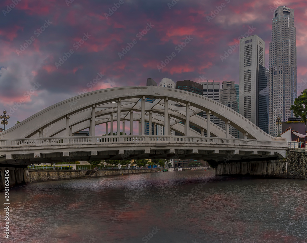 Naklejka premium A view from a boat on the Singapore river just after sunset towards the Elgin Bridge in Singapore, Asia