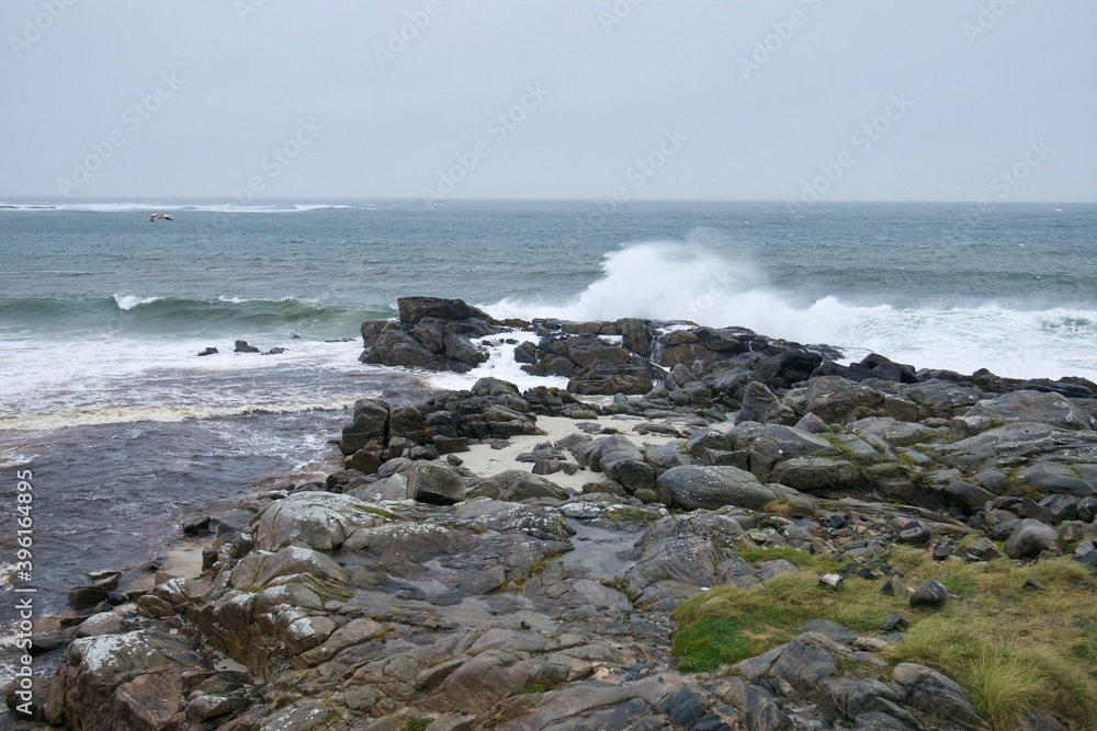 Angry ocean waves crushing against stone Scottish shore on a very windy day on the Isle of Barra Angry ocean waves crushing against stone Scottish shore on a very windy day on the Isle of Barra