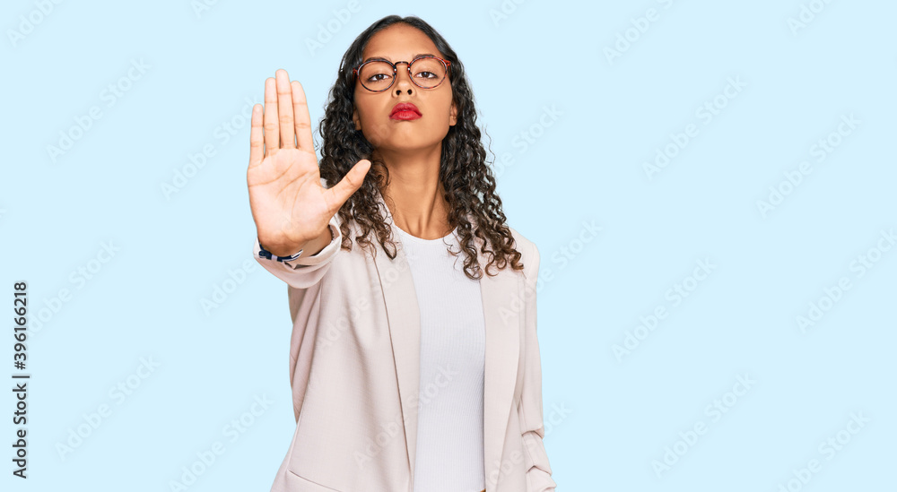 Young african american girl wearing business clothes doing stop sing with palm of the hand. warning expression with negative and serious gesture on the face. Young african american girl wearing business clothes doing stop sing with palm of the hand. warning expression with negative and serious gesture on the face.
