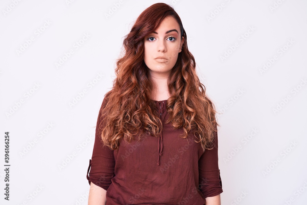 Young beautiful woman wearing casual clothes with serious expression on face. simple and natural looking at the camera. Young beautiful woman wearing casual clothes with serious expression on face. simple and natural looking at the camera.