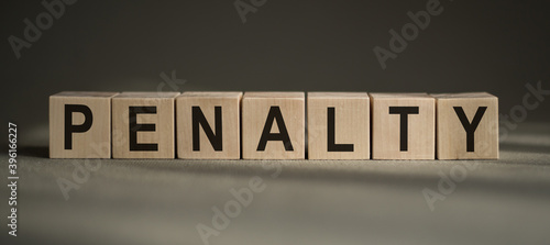 PENALTY word made up of building blocks on gray background. © Nastassia