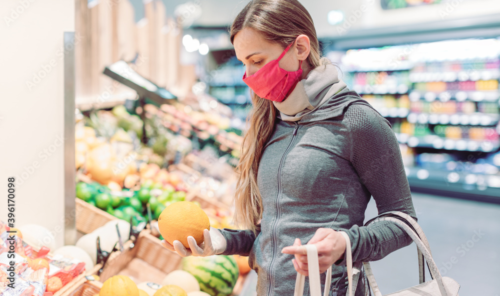 Woman shopping in supermarket during coronavirus lockdown