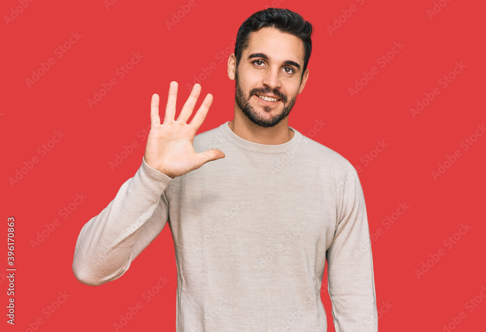 Young hispanic man wearing casual clothes showing and pointing up with fingers number five while smiling confident and happy. Young hispanic man wearing casual clothes showing and pointing up with fingers number five while smiling confident and happy.