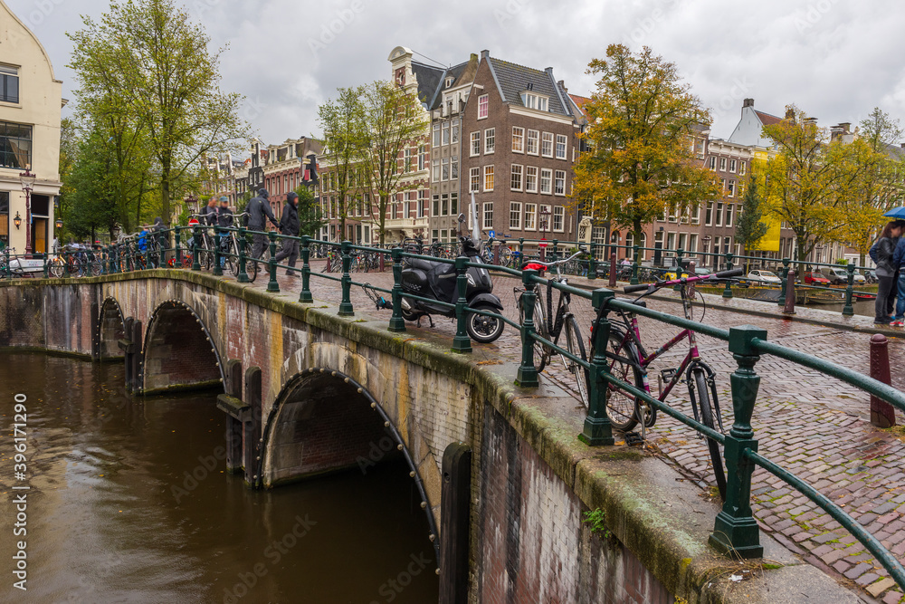 Amsterdam. Beautiful view of Amsterdam Canals with Bridge and typical Dutch Houses.