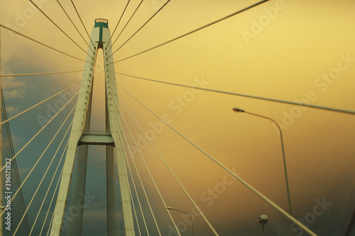 Cable-stayed bridge on the background of yellow clouds
