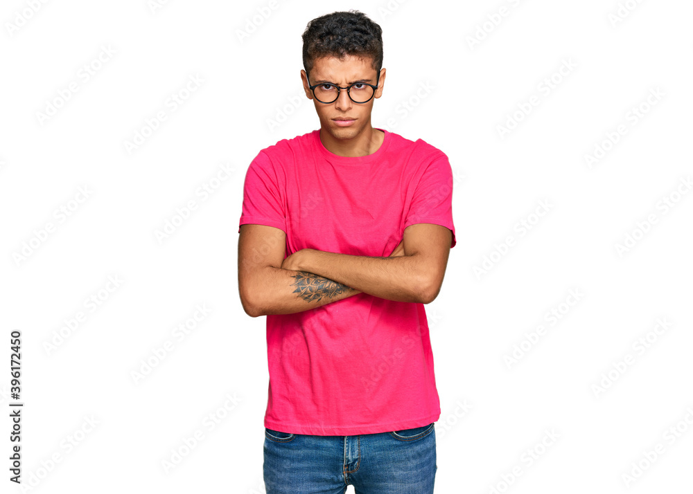 Young handsome african american man wearing casual clothes skeptic and nervous, disapproving expression on face with crossed arms. negative person. Young handsome african american man wearing casual clothes skeptic and nervous, disapproving expression on face with crossed arms. negative person.