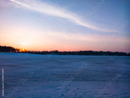 Beautiful sunset on the lake on a frosty day.