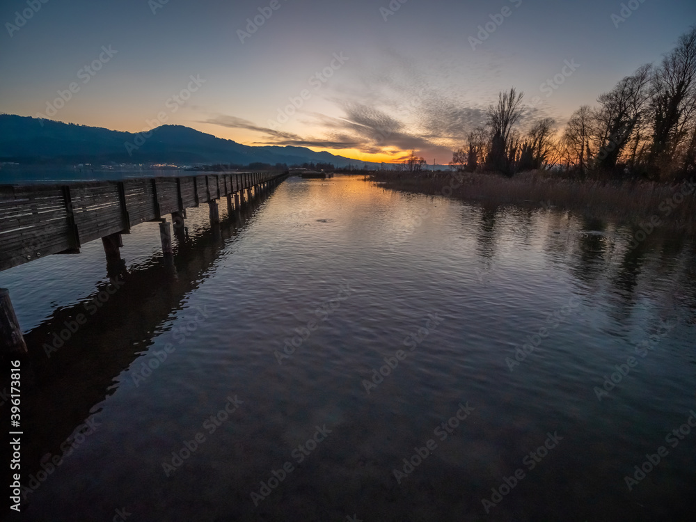 Stunning views of the historic wood bridge (Holzsteg) connecting the village of Hurden, Seedam, Schwyz with the city of Rapperswil, St. Gallen