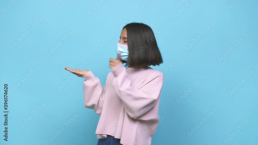 Young hispanic woman wearing antiviral mask screaming very angry and aggressive Young hispanic woman wearing antiviral mask screaming very angry and aggressive