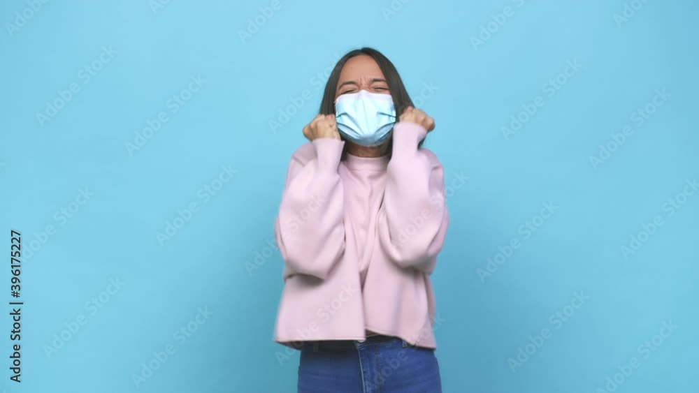Young hispanic woman wearing antiviral mask touching temples and having headache Young hispanic woman wearing antiviral mask touching temples and having headache
