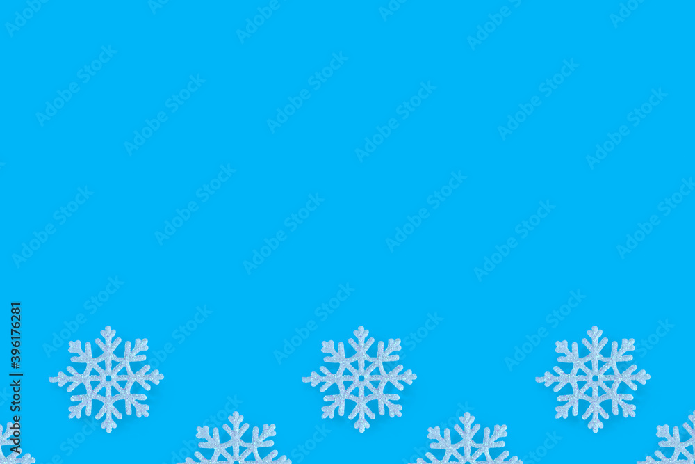 Christmas pattern of white snowflakes on a blue background. Concept banner frame border background for Christmas and New Year. Christmas pattern of white snowflakes on a blue background. Concept banner frame border background for Christmas and New Year.