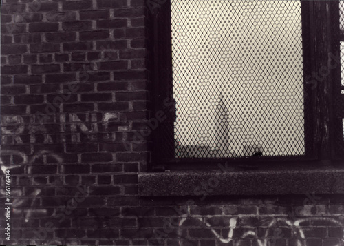 Brick wall with writings. Bars on the window. 3D rendering