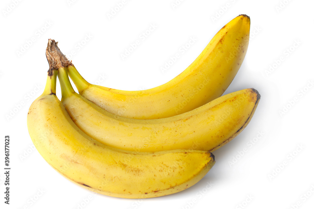Three yellow bananas close up on a white background