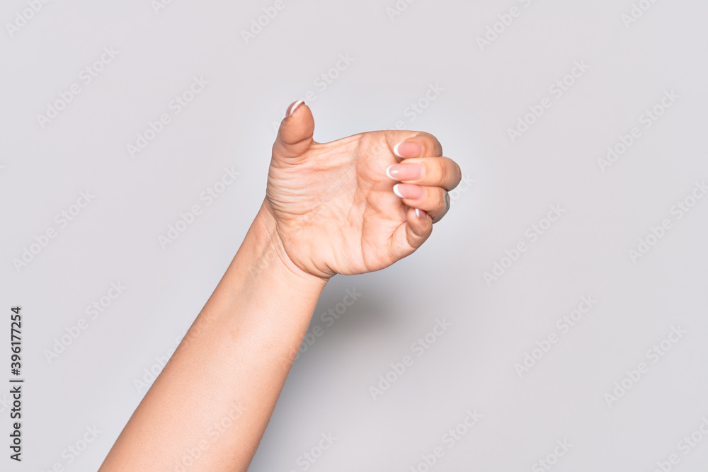 Hand of caucasian young woman holding invisible object, empty hand doing clipping and grabbing gesture Hand of caucasian young woman holding invisible object, empty hand doing clipping and grabbing gesture