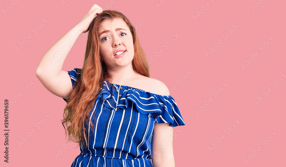 Young beautiful redhead woman wearing casual clothes confuse and wonder about question. uncertain with doubt, thinking with hand on head. pensive concept. Young beautiful redhead woman wearing casual clothes confuse and wonder about question. uncertain with doubt, thinking with hand on head. pensive concept.