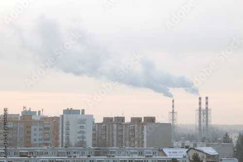 Industrial landscape smoke from the chimney of a large plant in winter.