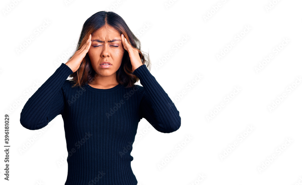 Young beautiful mixed race woman wearing casual clothes with hand on head for pain in head because stress. suffering migraine. Young beautiful mixed race woman wearing casual clothes with hand on head for pain in head because stress. suffering migraine.