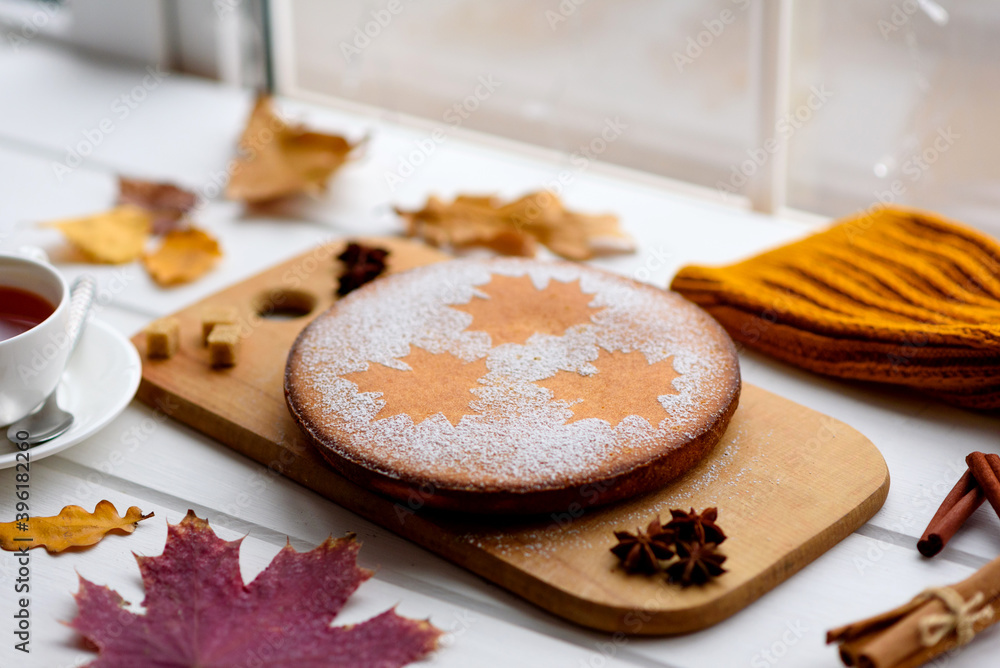 Beautiful fresh sweet pumpkin cake with a maple leaf pattern on a white wooden background Beautiful fresh sweet pumpkin cake with a maple leaf pattern on a white wooden background