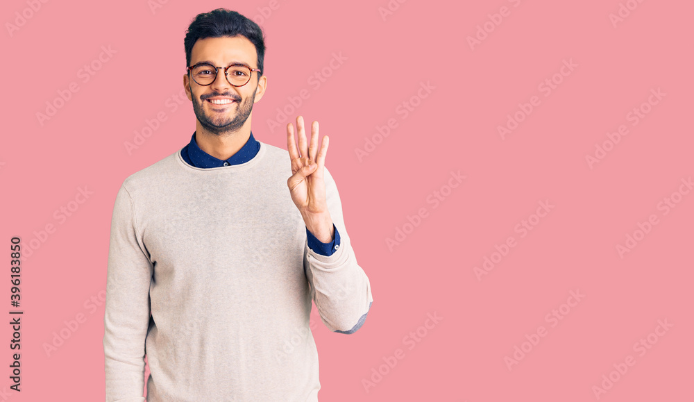 Young handsome hispanic man wearing elegant clothes and glasses showing and pointing up with fingers number four while smiling confident and happy. Young handsome hispanic man wearing elegant clothes and glasses showing and pointing up with fingers number four while smiling confident and happy.