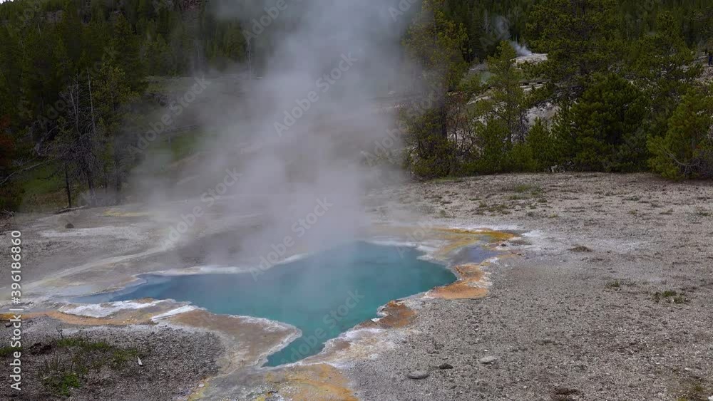 Boiling hot crystal clear water in a geyser. Yellowstone National park. Wyoming, USA Boiling hot crystal clear water in a geyser. Yellowstone National park. Wyoming, USA