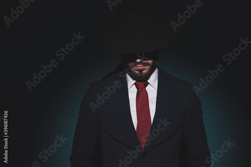 portrait of a mysterious businessman hidding in the shadows