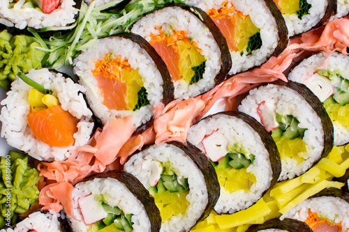 Sushi background. Tasty food on buffet party. Banquet snacks texture. Raw fish snacks. Japanese typical food texture. Catering table background. Wedding hotel restaurant.