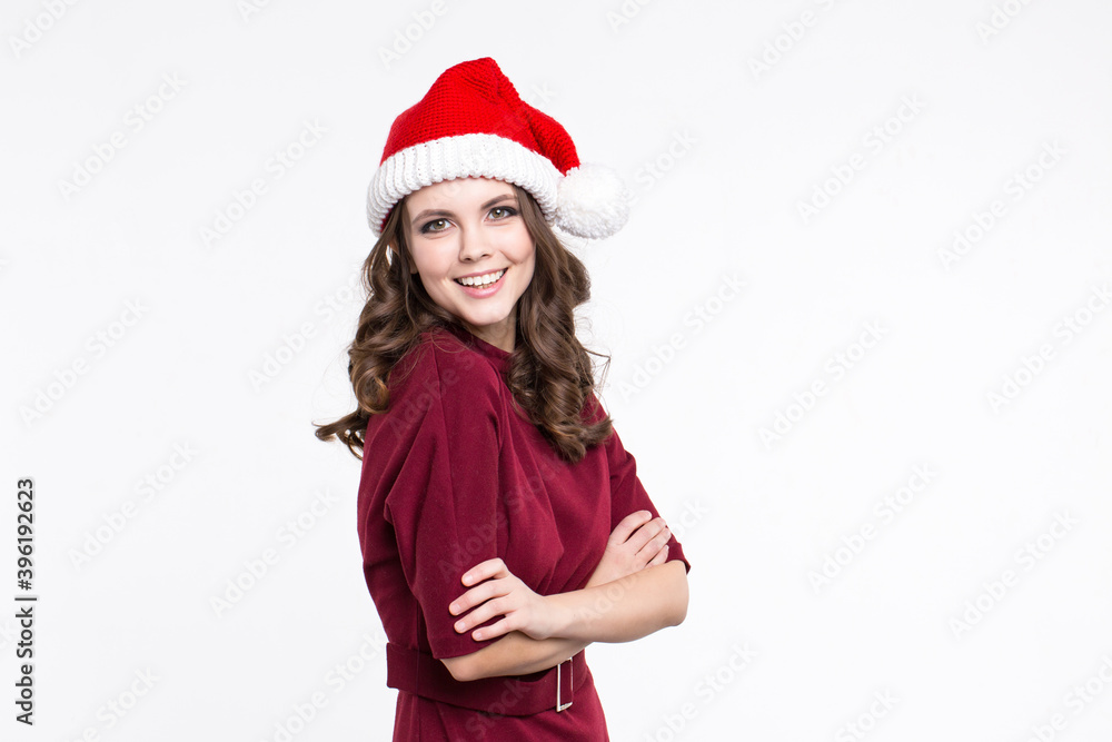 Portrait of a cheerful beautiful woman in a Santa hat on a white.