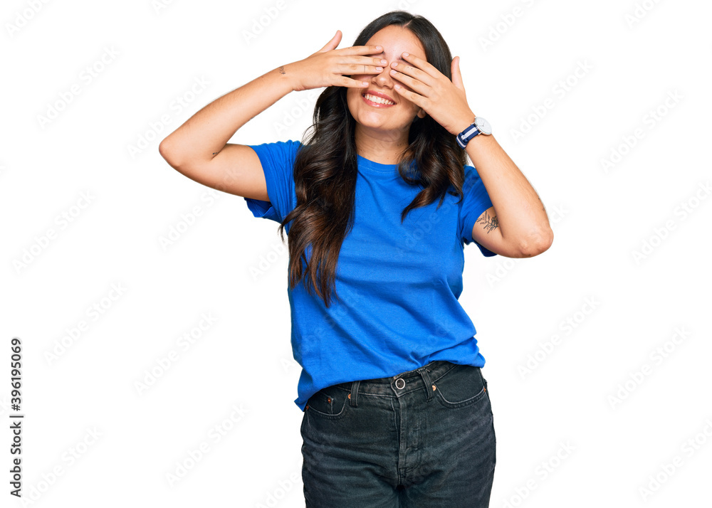 Beautiful brunette young woman wearing casual clothes covering eyes with hands smiling cheerful and funny. blind concept. Beautiful brunette young woman wearing casual clothes covering eyes with hands smiling cheerful and funny. blind concept.