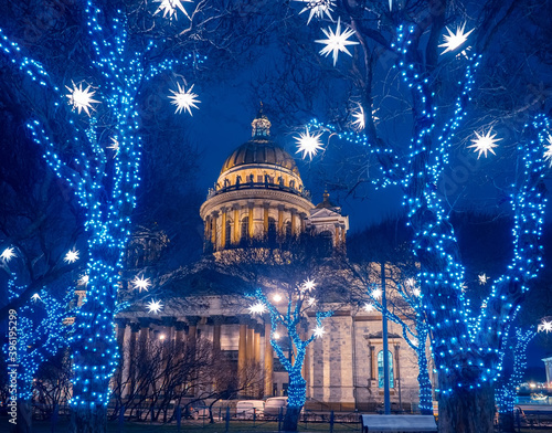 Christmas evening in Saint-Petersburg. New year in Russia. St. Isaac's Cathedral on the background of street garlands. Festive illumination in St. Petersburg. Russian cities in winter.